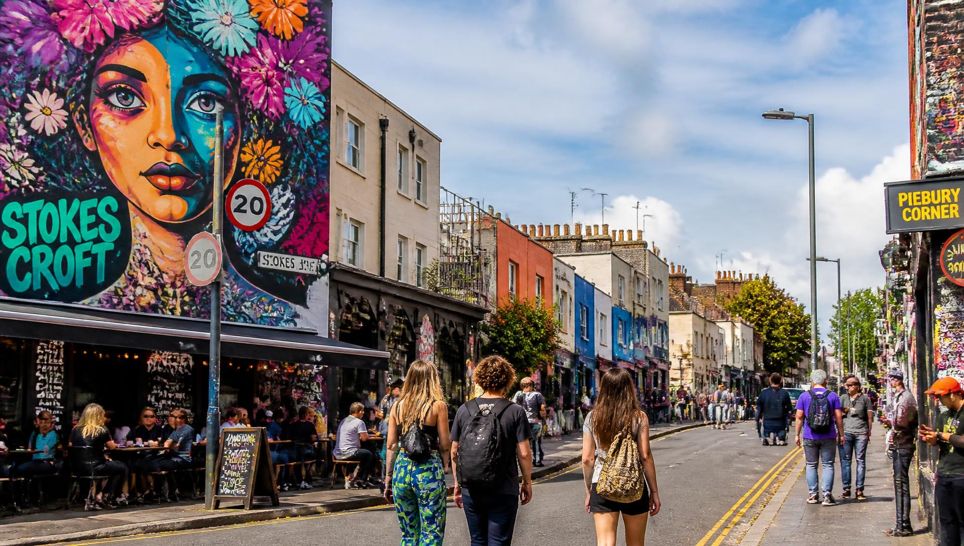 Street art mural and independent cafes on a Bristol street